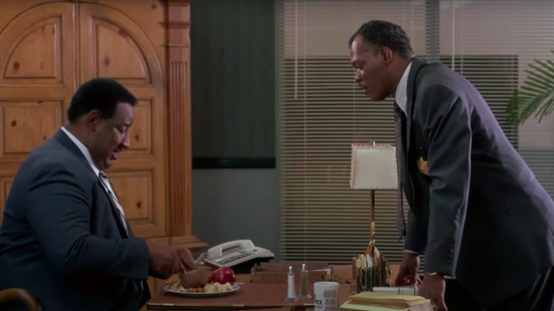 Samuel L Jackson standing over table, talking