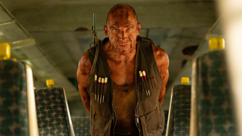 Ralph Fiennes as Dr. Ian Kelson standing in a train in 28 Years Later: The Bone Temple