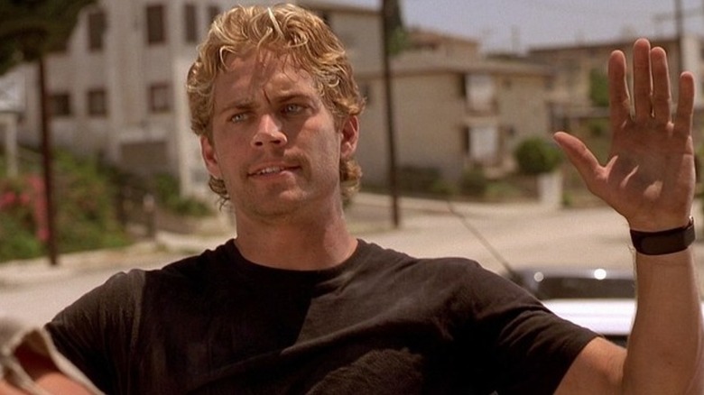 Brian looking tough, raising his hands in The Fast and the Furious