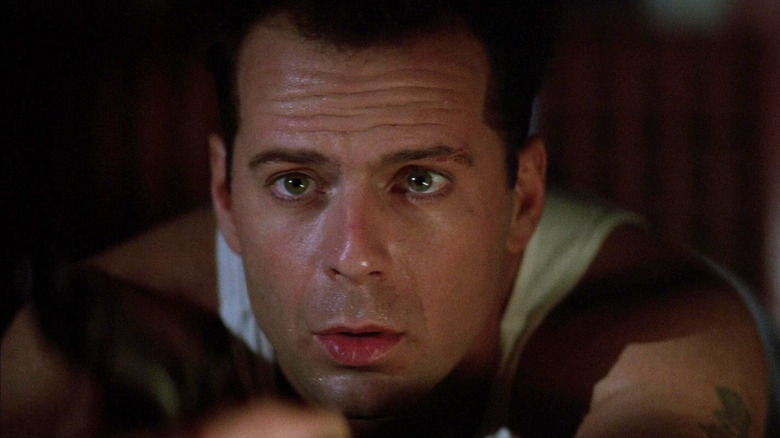 Bruce Willis as John McClane looks worried in Die Hard