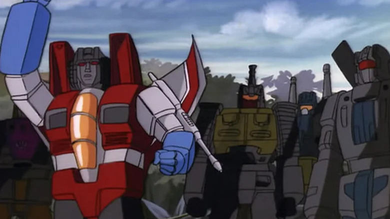 Starscream standing with Brawl, Onslaught, and Vortex in The Transformers