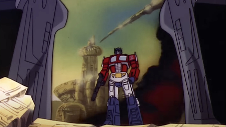 Optimus Prime framed through Megatron's legs on The Transformers