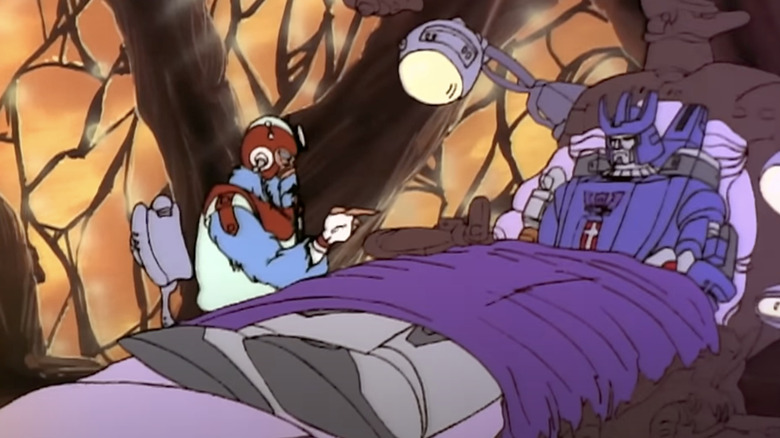 Galvatron bound to a bed next to a Torkulon therapist in The Transformers