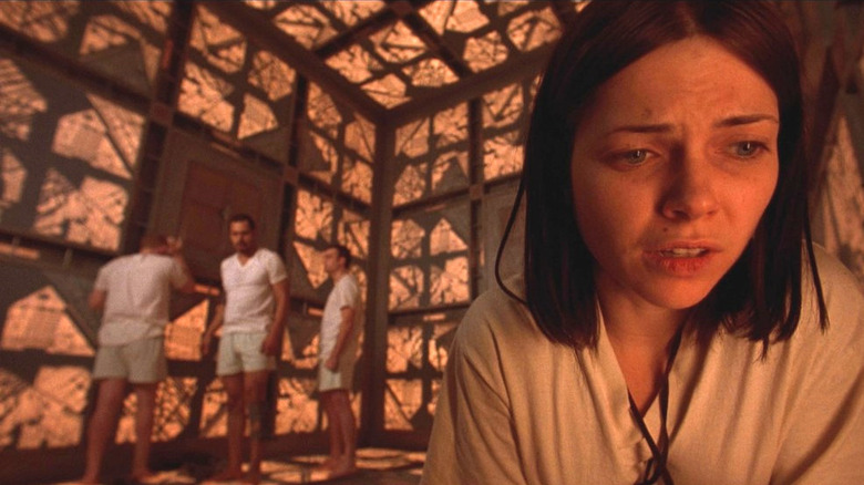 Leaven (Nicole de Boer) puzzles over escape from a geometric, booby-trapped room she's trapped in with strangers in "Cube" (1997)
