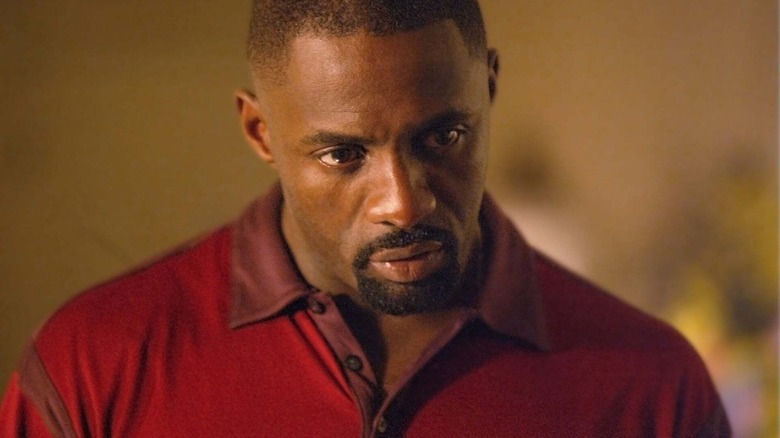 Stringer Bell in a red shirt looking unhappy in The Wire