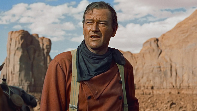 John Wayne as Ethan Edwards looking distrusting in The Searchers