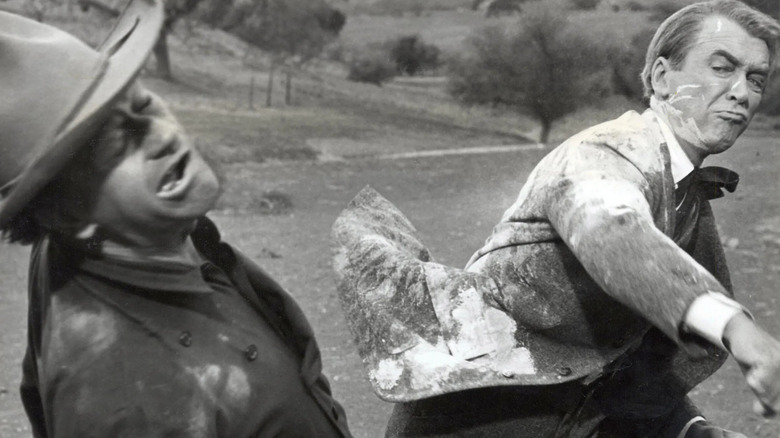 John Wayne as Tom Doniphon receiving a punch from James Stewart as Ransom Stoddard in The Man Who Shot Liberty Valance