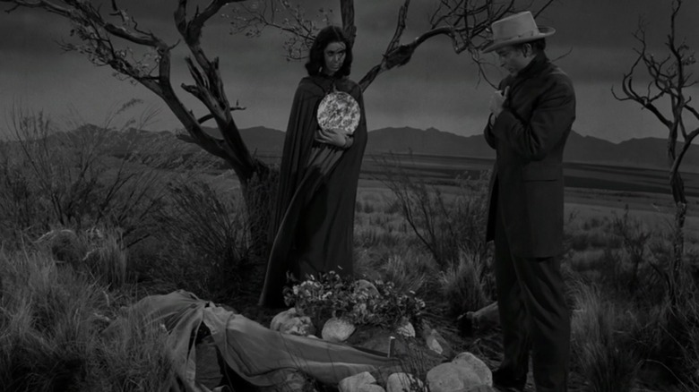 Two figures standing over the grave of Pinto Sykes in The Twilight Zone's "The Grave"