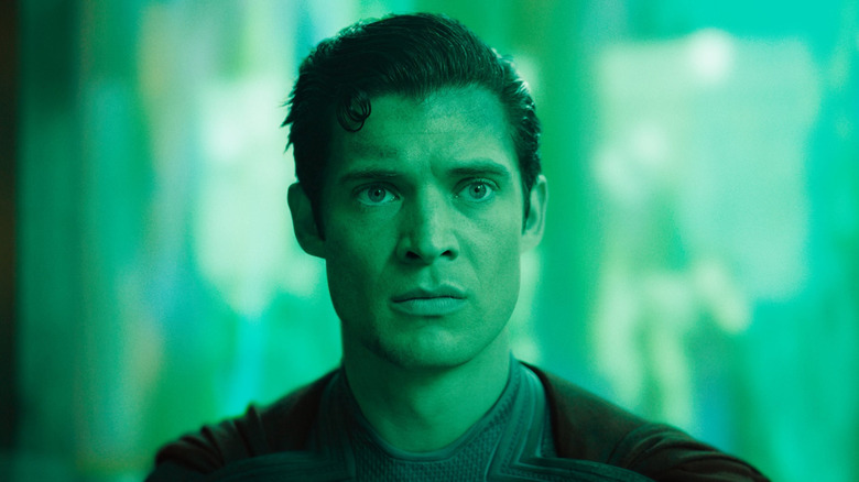 David Corenswet as Superman bathed in green light in Superman