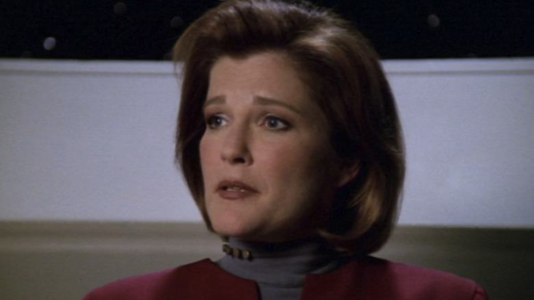 Captain Janeway with raised eyebrows looking at someone off camera in Star Trek: Voyager