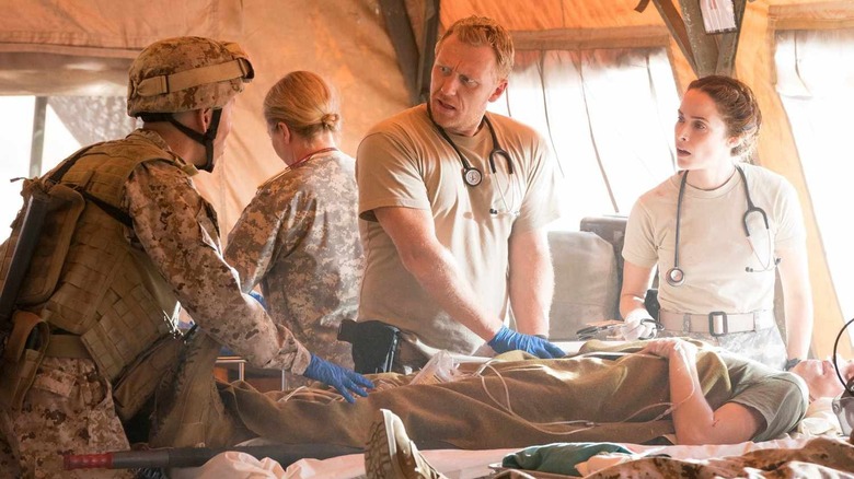 Owen and Megan performing surgery on an army base on Grey's Anatomy