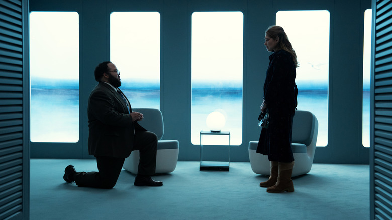 Zach Cherry's Dylan G. kneeling in front of Merritt Wever's Gretchen George on Severance