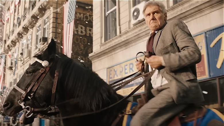 Indiana Jones races through a parade on horseback