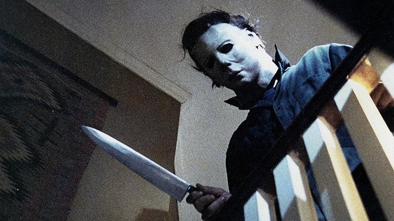 Michael Myers leaning over the stair railing in Halloween (1978)