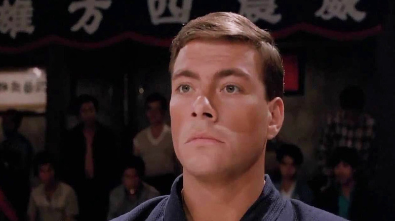 Jean-Claude Van Damme stands at attention as Frank Dux in Bloodsport