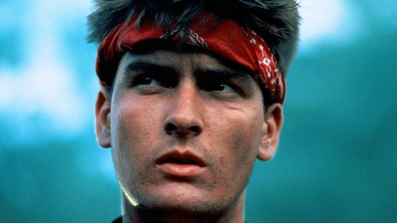 Chris Taylor wears a red head gang in the forest in the faction