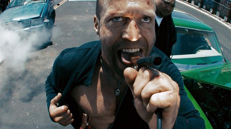 Jason Statham clamping his tongue with jumper cables