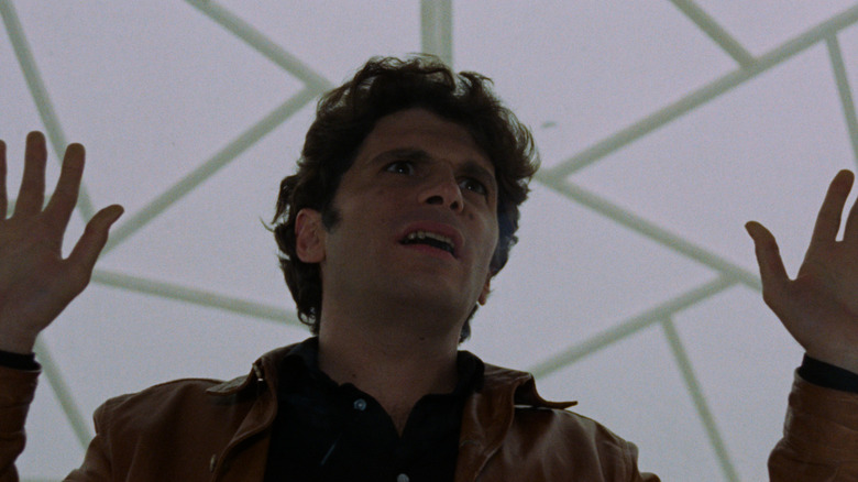 Man reaches for help in The Bird with the Crystal Plumage