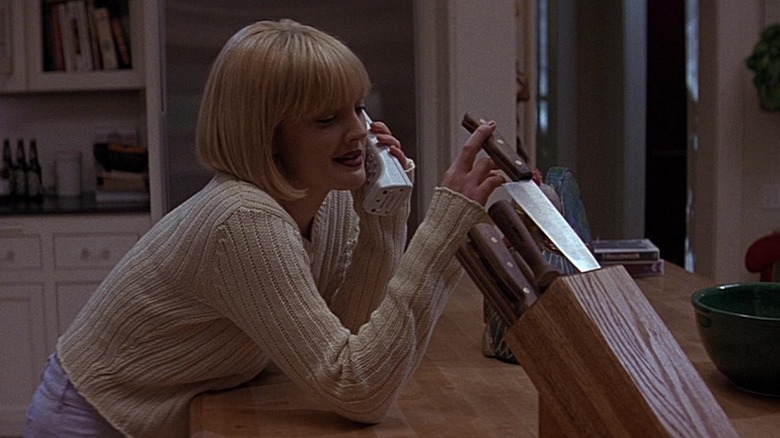 Drew Barrymore as Casey toying with a knife on the phone in Scream (1996)