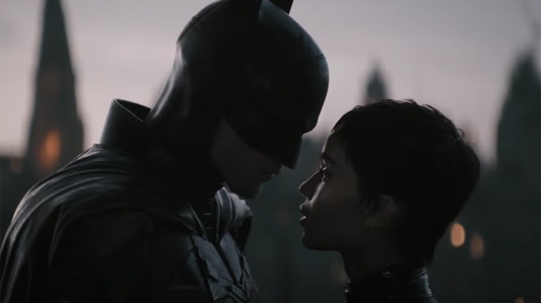 Batman stands close to Catwoman