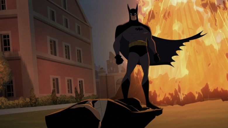 Batman stands over a knocked out thug in Batman Caped Crusader
