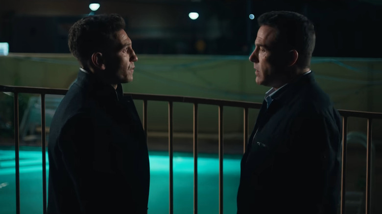 Braxton and Christian Wolff standing next to a motel pool in The Accountant 2