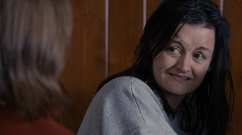 Justine looking at a child in The Accountant