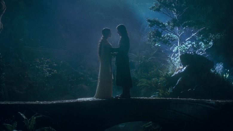 Arwen and Aragorn standing together in a garden in Rivendell in The Lord of the Rings: The Fellowship of the Ring