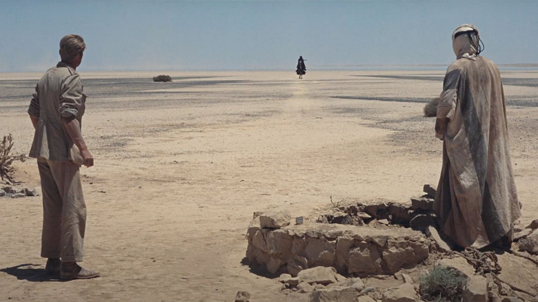 A distant figure approaching from the horizon in Lawrence of Arabia