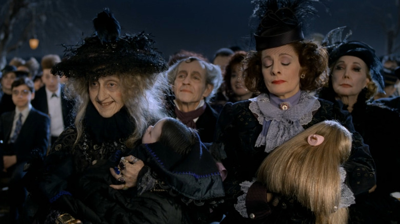 Carol Kane as Grandmama and Dana Ivey as Margaret, each holding an infant in Addams Family Values