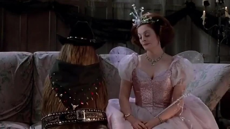 Cousin Itt and Margaret sit on couch in Halloween costumes