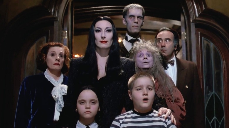 The Addams Family in front of a doorframe