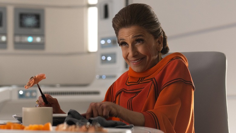 Eedy Karn (Kathryn Hunter) sitting at the dinner table in "Andor"