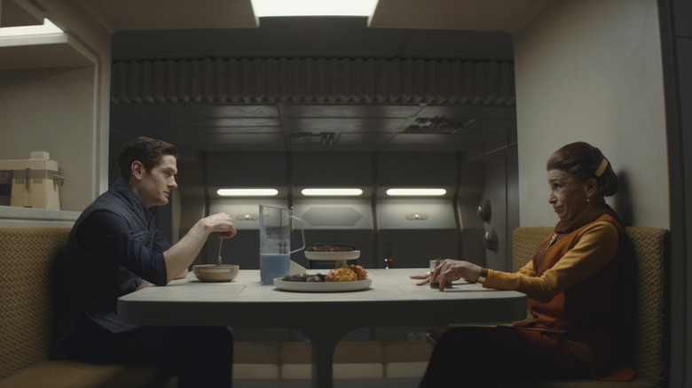 Syril Karn (Kyle Soller) and Eedy Karn (Kathryn Hunter) sit together at the dinner table in "Andor"