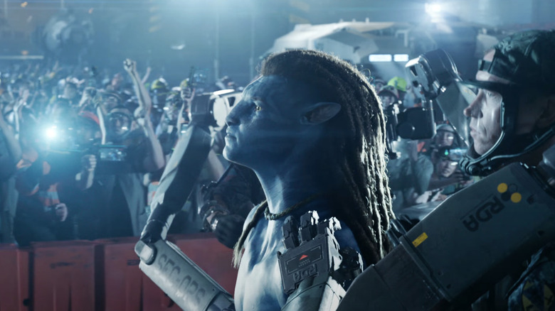 Jake apprehended by the RDA as onlookers watch in Avatar: Fire and Ash