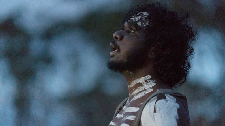 Baykali Ganambarr as Mangana dressed in war paint in The Nightingale (2018)