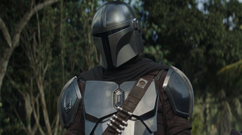 The Mandalorian in his helmet and armor looking out