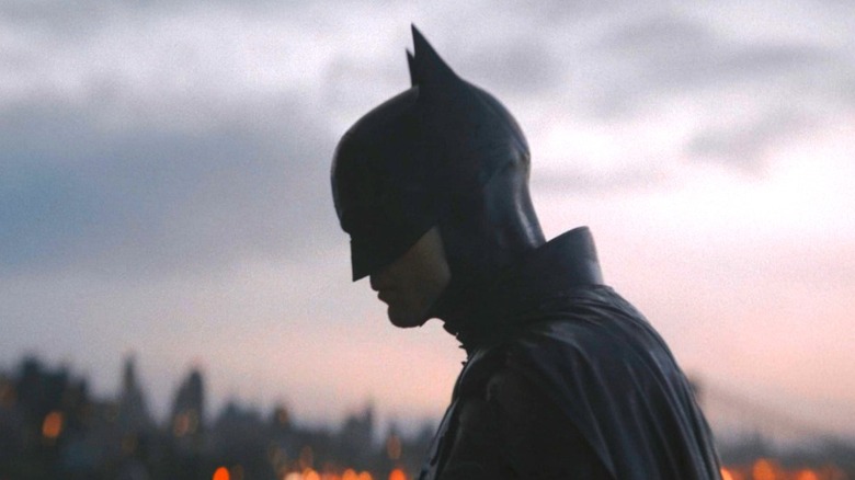 The Batman in silhouette on a rooftop