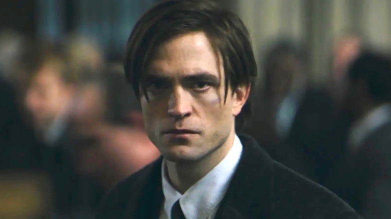 Bruce Wayne in a suit facing forward