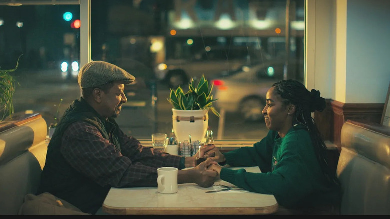 Emmanuel and Sydney holding hands at a diner on The Bear