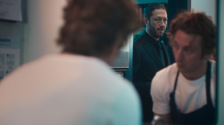 Richie is looking at Carmy who looks at Richiee, reflecting in the mirror of the bear season 4