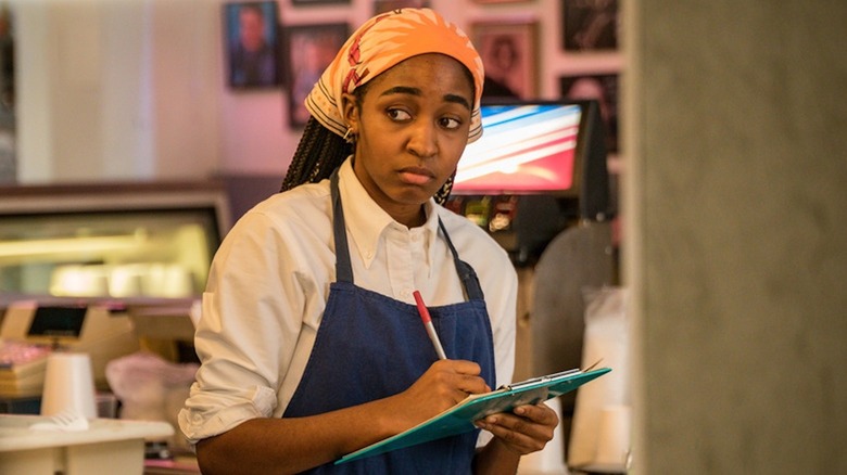Ayo Edebiri as Syd Adamu shoots a skeptical glance in The Bear