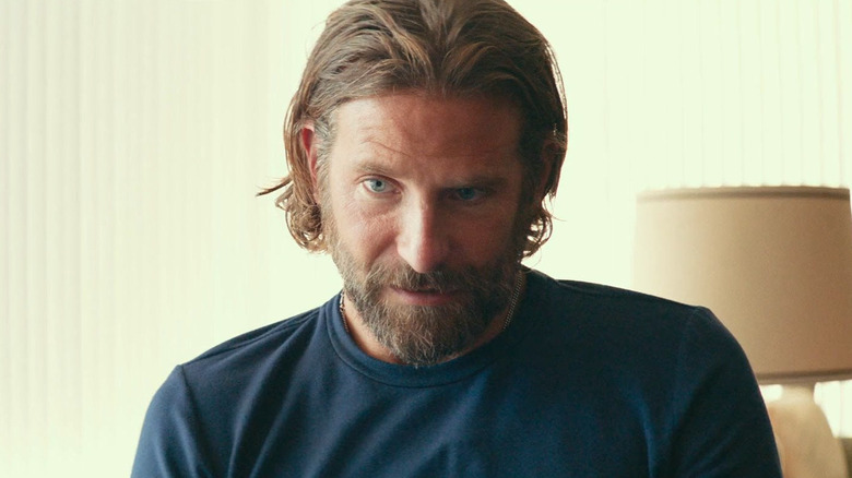 Bradley Cooper as Jackson Maine looking regretful in A Star Is Born