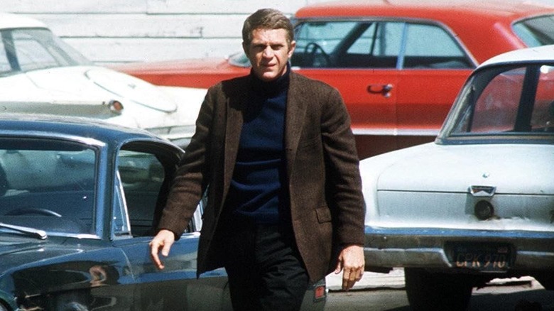 Steve McQueen walks in parking lot