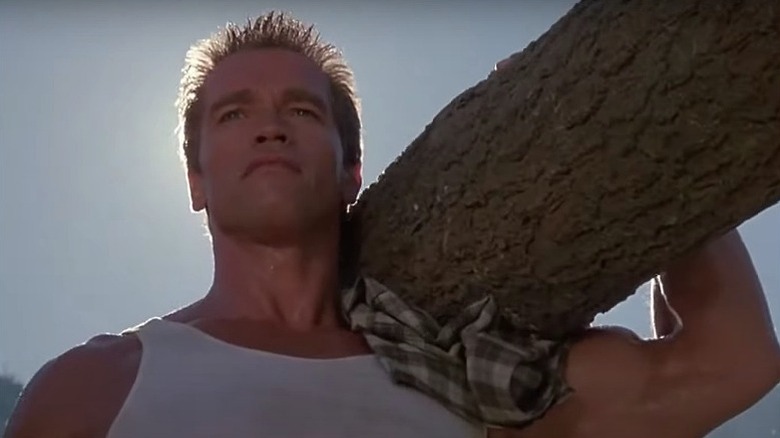 Commando Shwarzenegger carries log