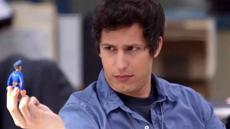 Jake Peralta holding a police figurine