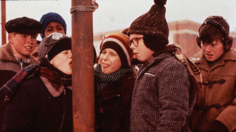 Boy with tongue frozen to pole