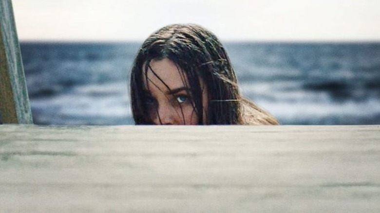 A woman peeks over the dock