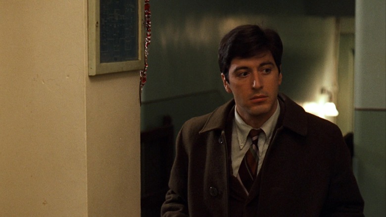 Al Pacino as Michael Corleone standing in a hospital corridor in The Godfather