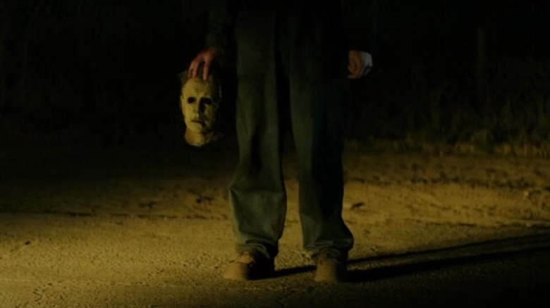 Man holding Michael Myers mask